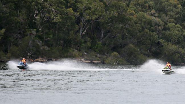 Jet skiers take advantage of the warmer weather and head out on the Georges River on Sunday. Picture: Ian Svegovic